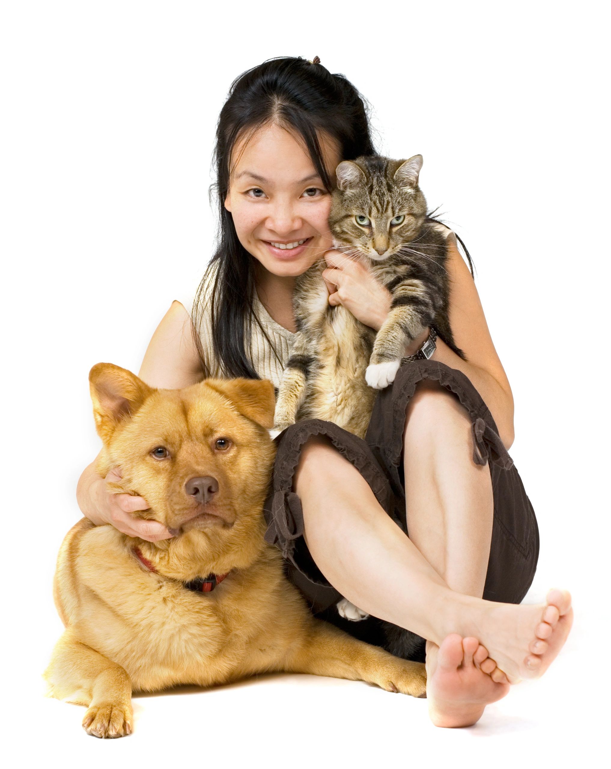 Woman hugging her cat and dog