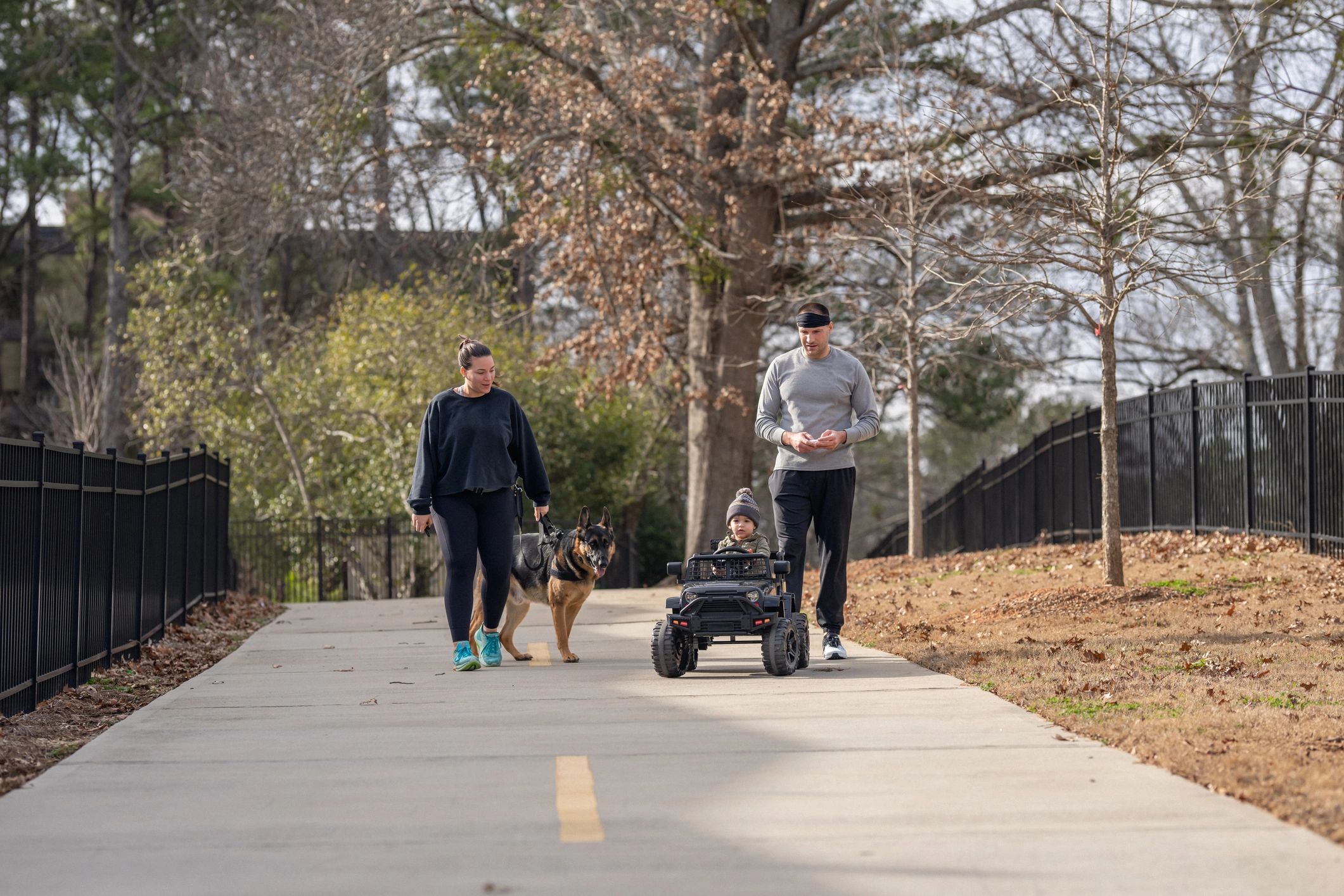 Happy family walking with their dog outdoors
