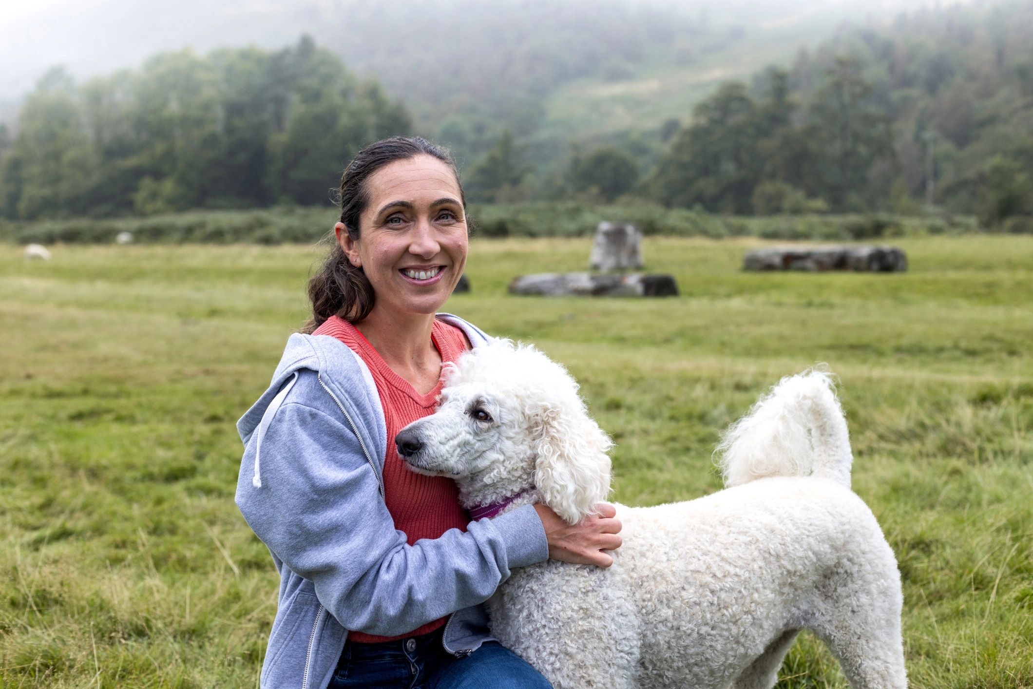 Pet owner smiling with dog outdoors