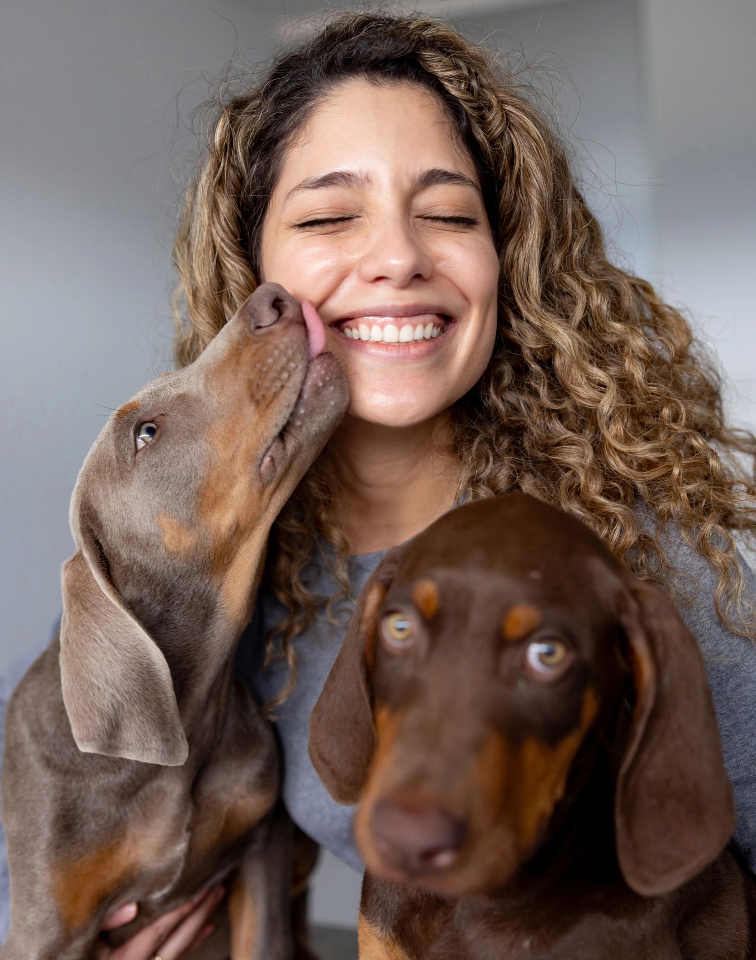 Smiling pet lover with puppies